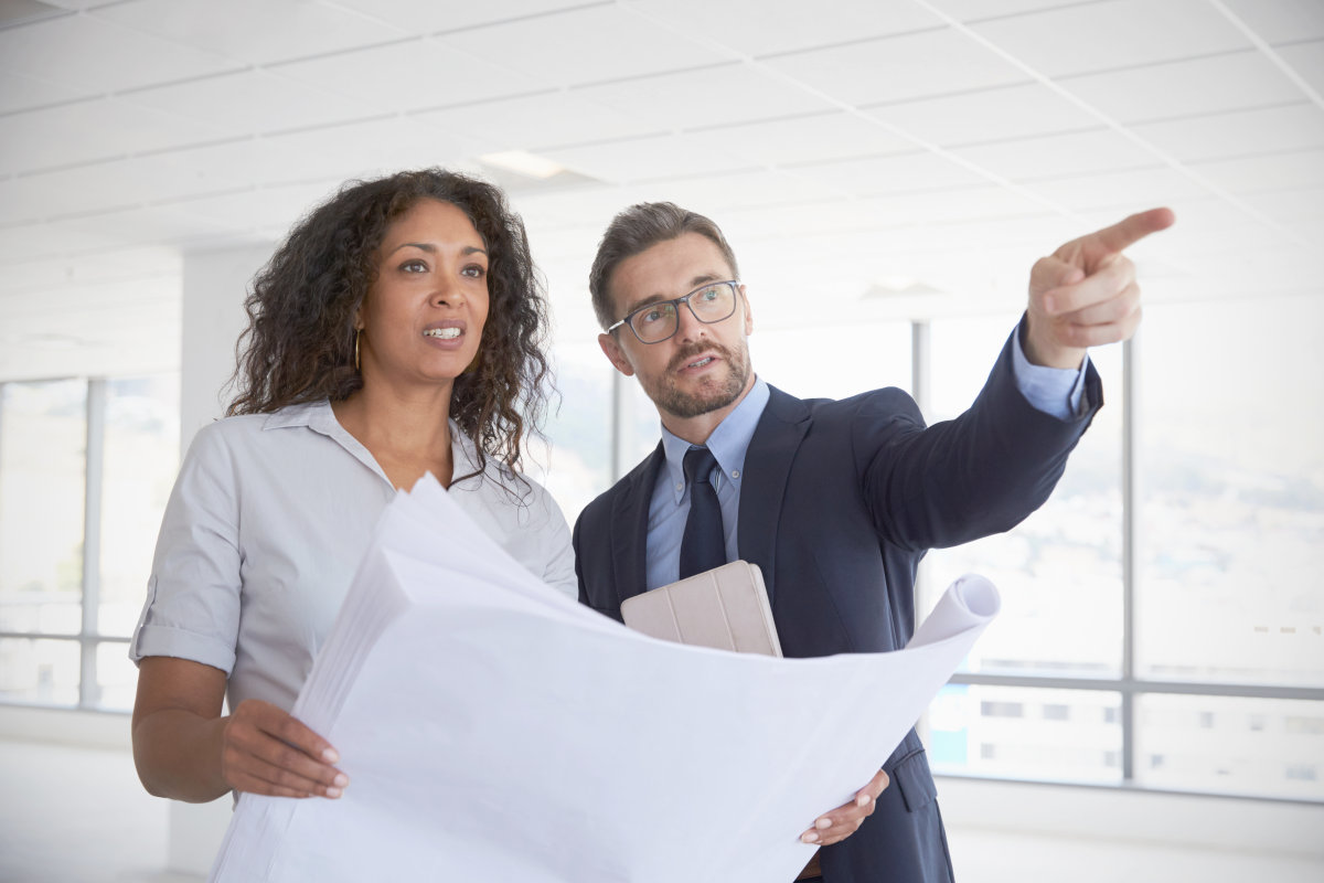 Businesspeople Meeting To Look At Plans | End Procrastination With These 9 Time Management Strategies